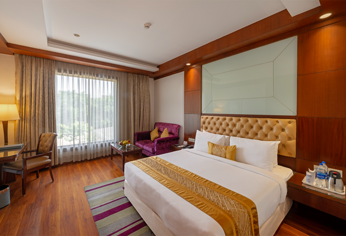 Junior Suite bedroom at City Park Green Resort, New Delhi